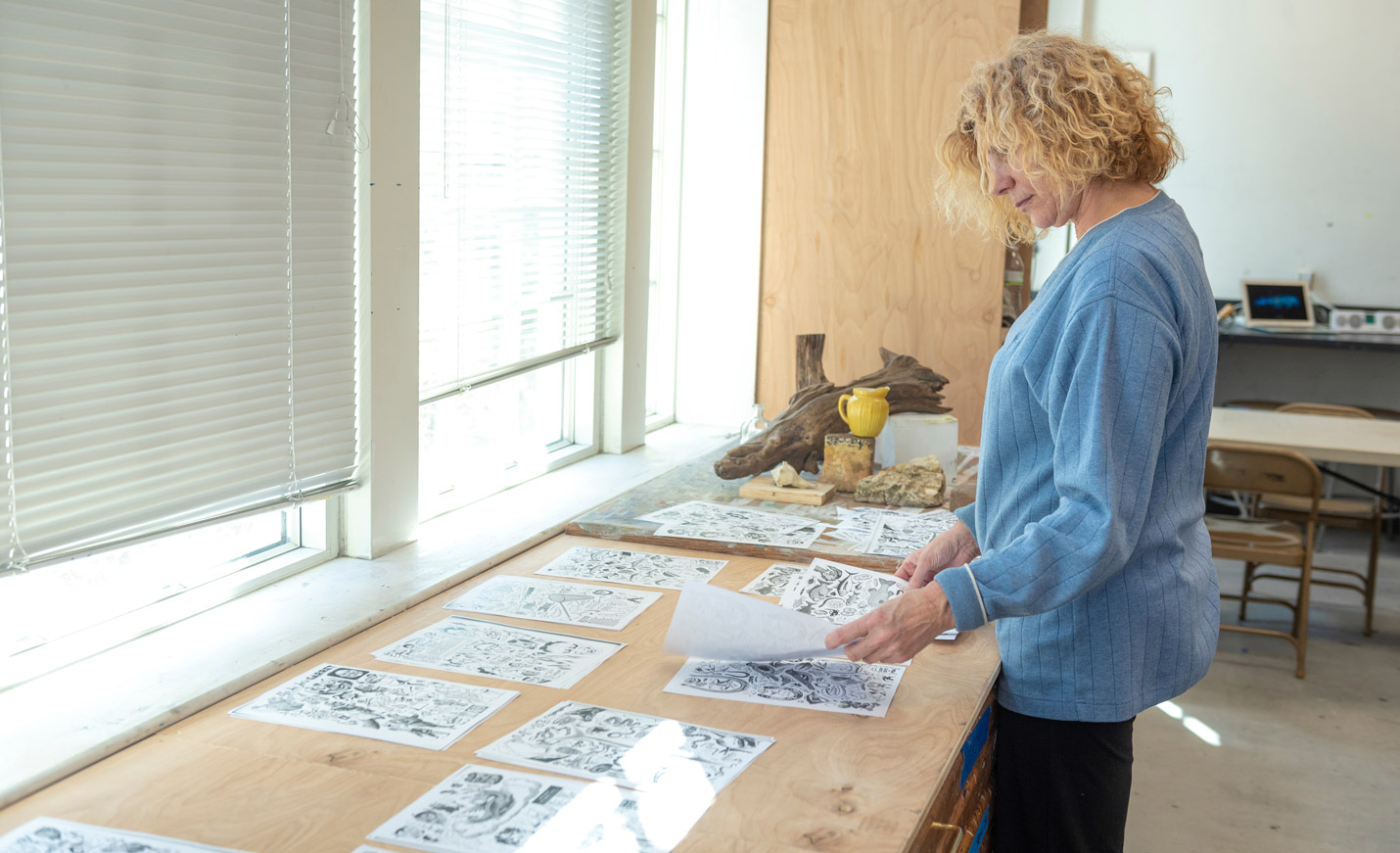 professor looking over art illustrations