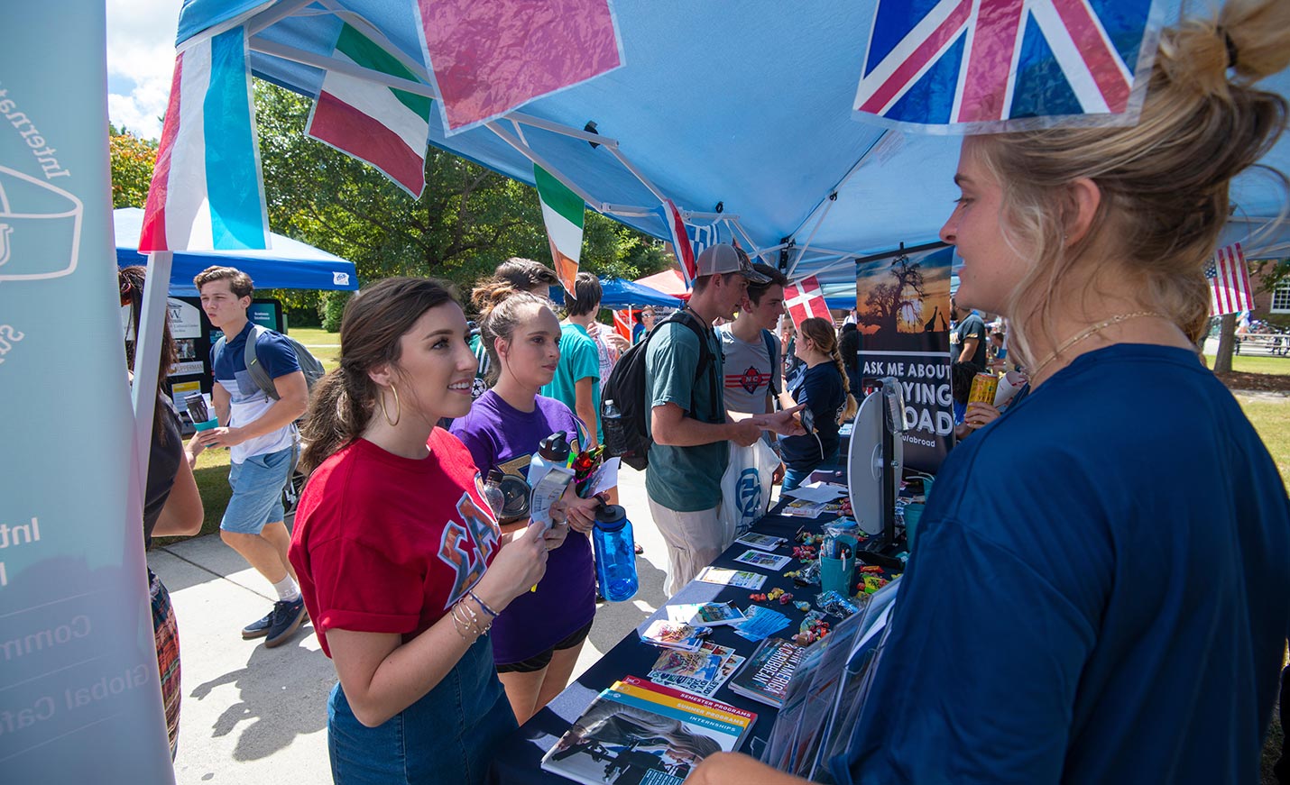 students stop at the study abroad booth at the Involvement Carnival