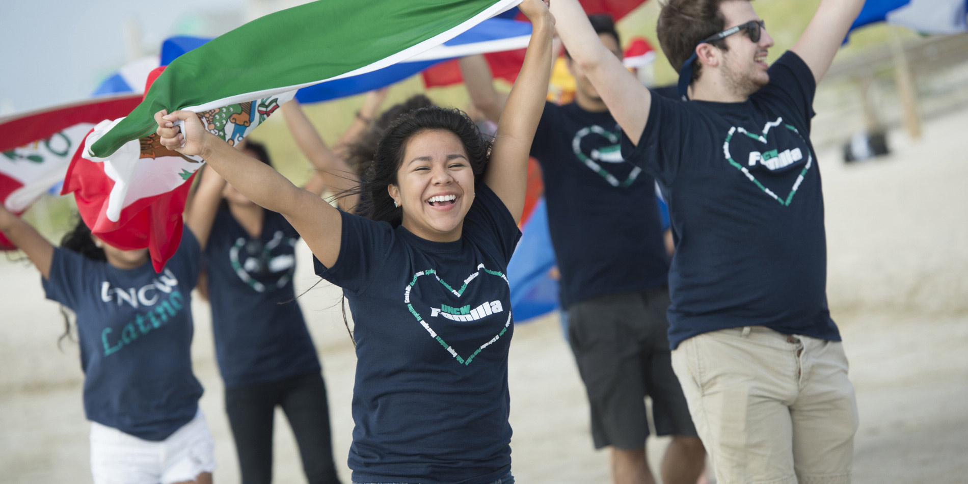 Students carry flags overhead.