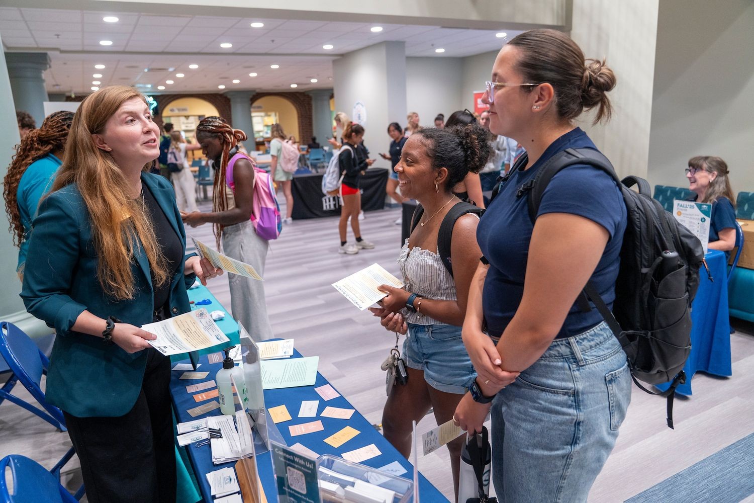 people talking at a Job fair booth held on campus